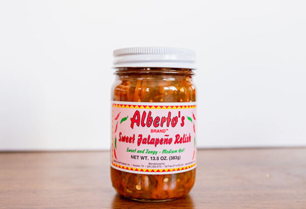A jar of sweet jalapeno relish on top of a table.