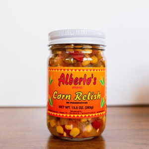 A jar of corn relish on top of a table.