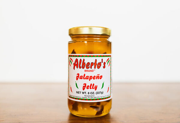 A jar of jalapeno jelly on top of a table.