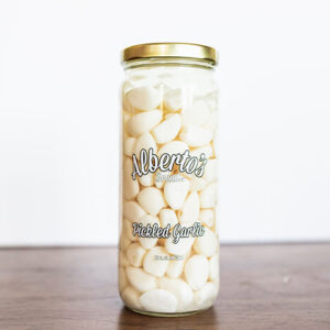 A jar of marshmallows on top of a table.